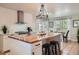 Bright kitchen features a large butcher block island, white cabinets and stainless steel appliances at 5886 Urban St, Arvada, CO 80004