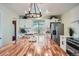 This kitchen features stainless steel appliances, white cabinets and a butcher block island at 5886 Urban St, Arvada, CO 80004
