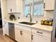 Bright kitchen featuring stainless steel appliances, sleek countertops, and stylish sink with ample cabinet space at 5886 Urban St, Arvada, CO 80004
