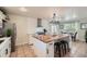 A spacious kitchen features a butcher block island, stainless steel appliances and dining area at 5886 Urban St, Arvada, CO 80004