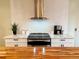 Modern kitchen with stainless steel appliances, sleek countertops, and a stylish range hood, perfect for cooking at 5886 Urban St, Arvada, CO 80004