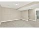 Finished basement area with neutral walls, carpet, and access to another room at 9885 Thornbury Way, Highlands Ranch, CO 80129
