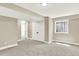 Finished basement area with neutral walls, carpet, closet and a window for natural light at 9885 Thornbury Way, Highlands Ranch, CO 80129