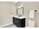 Elegant bathroom features a blue vanity with modern hardware and fixtures at 9885 Thornbury Way, Highlands Ranch, CO 80129