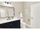 Modern bathroom boasts a stylish vanity with black fixtures, sleek mirror, and white door at 9885 Thornbury Way, Highlands Ranch, CO 80129