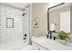 Modern bathroom featuring a shower, vanity, framed mirror, and stylish black hardware at 9885 Thornbury Way, Highlands Ranch, CO 80129