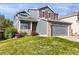 Charming two-story home with red shutters, a gray garage, and a well-manicured front yard at 9885 Thornbury Way, Highlands Ranch, CO 80129