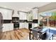 Modern kitchen featuring white cabinets, stainless steel appliances, and a contrasting backsplash at 9885 Thornbury Way, Highlands Ranch, CO 80129