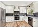 Kitchen featuring white cabinets, stainless steel appliances and hardwood floors at 9885 Thornbury Way, Highlands Ranch, CO 80129