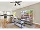 Open concept living area with hardwood floors, ample seating, and a view into the bright, modern kitchen at 9885 Thornbury Way, Highlands Ranch, CO 80129