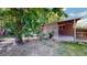 Spacious backyard featuring a covered patio and ample green space at 8438 Ames St, Arvada, CO 80003