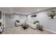 Finished basement featuring gray walls, neutral carpet, and comfortable seating arrangements at 8438 Ames St, Arvada, CO 80003