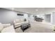 Basement features a carpeted living room area and kitchen and dining area at 8438 Ames St, Arvada, CO 80003