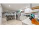 Open basement area featuring a kitchen open to the dining area and living room at 8438 Ames St, Arvada, CO 80003