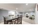 Open basement area featuring a large tv, neutral carpet, and dining area at 8438 Ames St, Arvada, CO 80003