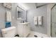 Bathroom features a single vanity, marble shower, and neutral tiling at 8438 Ames St, Arvada, CO 80003