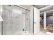 Bright and clean shower with a seamless glass door and neutral tiling at 8438 Ames St, Arvada, CO 80003