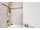 Bathroom shower is tiled and features convenient storage for shampoo and shower gel at 8438 Ames St, Arvada, CO 80003