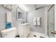 Bathroom features a single vanity, marble shower, and neutral tiling at 8438 Ames St, Arvada, CO 80003