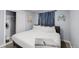 Cozy bedroom with a soft color palette, and neutral-toned carpet with natural light at 8438 Ames St, Arvada, CO 80003