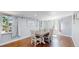 Bright dining room features hardwood floors and a rustic-style dining table at 8438 Ames St, Arvada, CO 80003