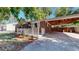 Well-kept brick home with tidy landscaping, showcasing a welcoming front exterior at 8438 Ames St, Arvada, CO 80003