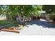 Brick home featuring a well-maintained lawn and a large tree, offering shade and curb appeal at 8438 Ames St, Arvada, CO 80003
