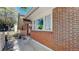 Charming front porch with white railing, adding character to the brick home's facade at 8438 Ames St, Arvada, CO 80003