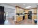 Efficient kitchen design with wood cabinets, granite countertops, and modern appliances at 8438 Ames St, Arvada, CO 80003