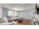Relaxing living room with wood floors, light walls, and comfortable white couches at 8438 Ames St, Arvada, CO 80003