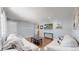 Cozy living room featuring hardwood floors, light gray walls, and white couches at 8438 Ames St, Arvada, CO 80003