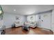 Inviting living room showcases wood flooring and is furnished with comfortable seating at 8438 Ames St, Arvada, CO 80003