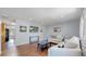 Bright living room boasts hardwood floors and stylish, neutral-toned furniture at 8438 Ames St, Arvada, CO 80003