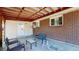 Covered patio with brick detail, offering a comfortable outdoor seating area at 8438 Ames St, Arvada, CO 80003