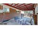 Relaxing covered patio space with seating, perfect for outdoor entertaining and enjoying the backyard at 8438 Ames St, Arvada, CO 80003