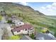 Stunning aerial view of home with balcony, set against a backdrop of mountain and lush greenery at 415 Butte Pkwy, Golden, CO 80403