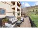 Spacious back deck featuring wicker patio furniture, a hot tub, and stunning views of the hillside at 415 Butte Pkwy, Golden, CO 80403