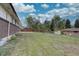 Expansive backyard with lush lawn, mature trees, and shed offers endless possibilities for outdoor enjoyment and entertainment at 9584 W Kentucky Ave, Lakewood, CO 80226