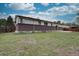 Large, fenced backyard featuring a well-maintained lawn and brick accents provides a secure and inviting outdoor space at 9584 W Kentucky Ave, Lakewood, CO 80226