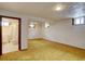 Spacious basement with finished floors, windows, and an adjacent bathroom at 9584 W Kentucky Ave, Lakewood, CO 80226