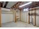 Unfinished basement area with exposed ceiling and open closet with shelving at 9584 W Kentucky Ave, Lakewood, CO 80226