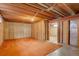 Unfinished basement space with exposed wood beams and concrete walls at 9584 W Kentucky Ave, Lakewood, CO 80226
