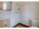 Outdated bathroom design with patterned wallpaper, white tile, and a pink toilet at 9584 W Kentucky Ave, Lakewood, CO 80226