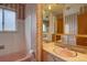 Bathroom featuring pink fixtures, floral wallpaper, and vintage detailing at 9584 W Kentucky Ave, Lakewood, CO 80226