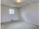 Simple bedroom with neutral walls and carpet, a single window providing natural light at 9584 W Kentucky Ave, Lakewood, CO 80226