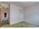 Bedroom features green carpet, a closet, and an open doorway to the rest of the house at 9584 W Kentucky Ave, Lakewood, CO 80226