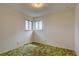 Cozy bedroom featuring natural light from two windows and a unique green carpet at 9584 W Kentucky Ave, Lakewood, CO 80226