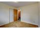 Basic bedroom with neutral carpet, white walls, and standard closet space at 9584 W Kentucky Ave, Lakewood, CO 80226
