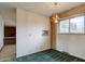 Dining room with vintage chandelier and large window, connecting to kitchen at 9584 W Kentucky Ave, Lakewood, CO 80226