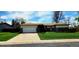 Charming single-story home featuring a two-car garage and a well-maintained front yard with a long driveway at 9584 W Kentucky Ave, Lakewood, CO 80226